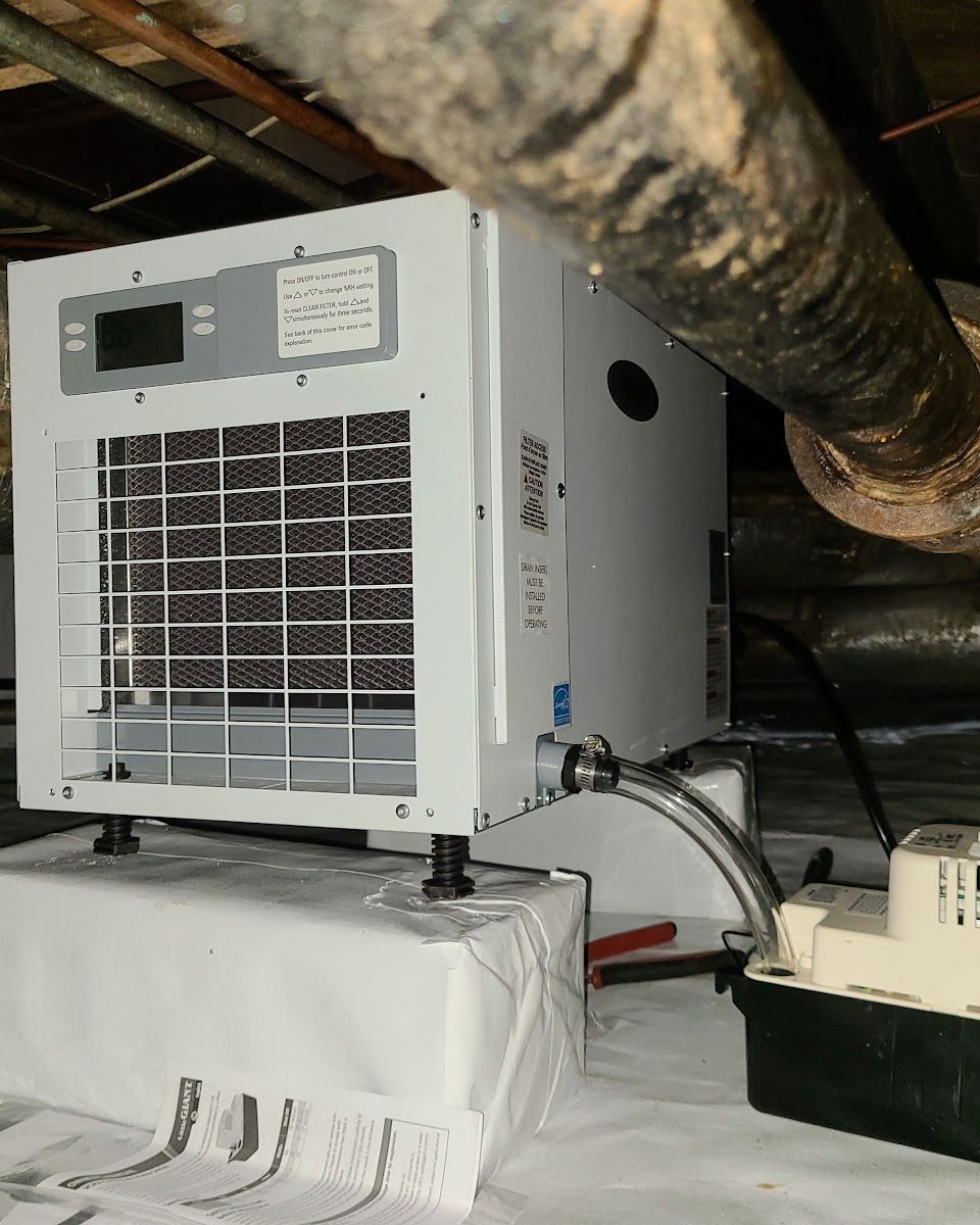 Crawl space dehumidifier and drainage system installed as part of an encapsulation job